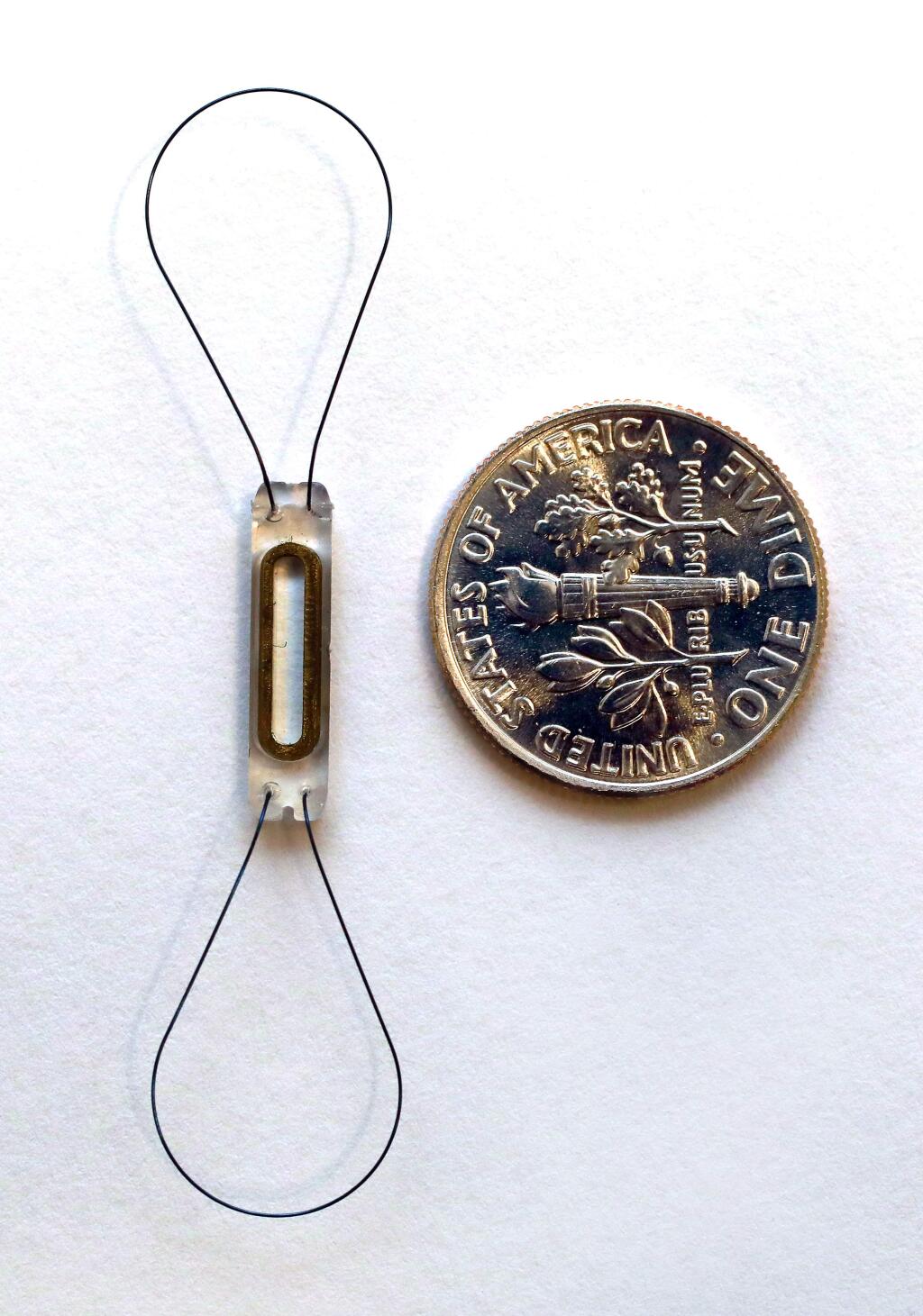 The CardioMems Heart Failure system, left, is implanted in an artery in the heart to measure changes in blood pressures as an early warning system for detecting heart failure. (John Burgess/The Press Democrat)