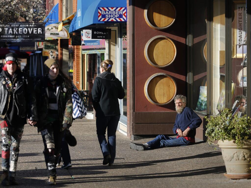 A homeless man asks passersby for money outside of Corrick's in Santa Rosa on Thursday, Jan. 26, 2017. (BETH SCHLANKER/ PD FILE)