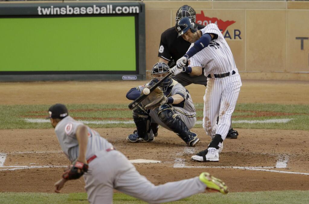 American League shortstop Derek Jeter, of the New York Yankees, singles during the third inning of the MLB All-Star baseball game, Tuesday, July 15, 2014, in Minneapolis. (AP Photo/Paul Sancya)