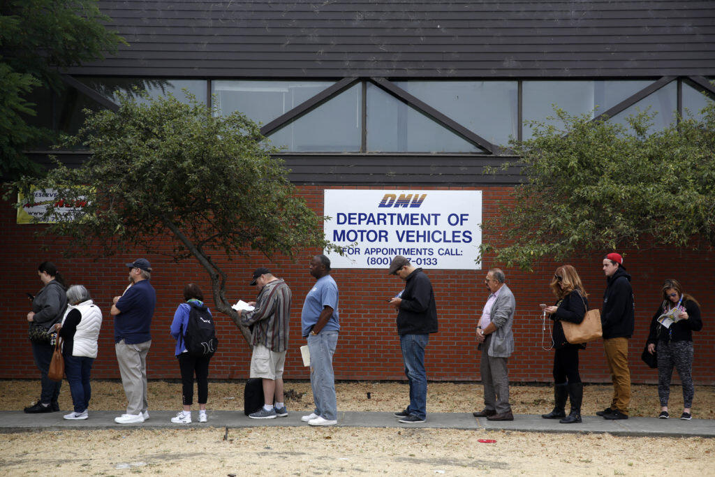 People wait in an hours long line at the Department of Motor Vehciles office on Corby Ave. in Santa Rosa on Monday, July 16, 2018. (Beth Schlanker/ The Press Democrat)