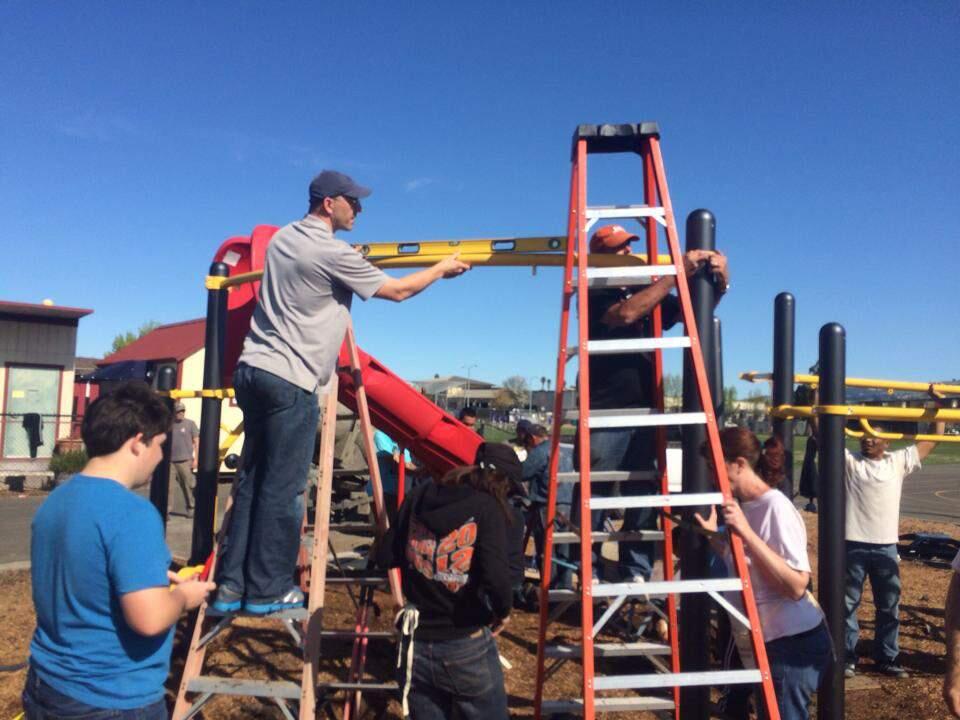 Volunteers work to give McDowell Elemetary School students a new playground.