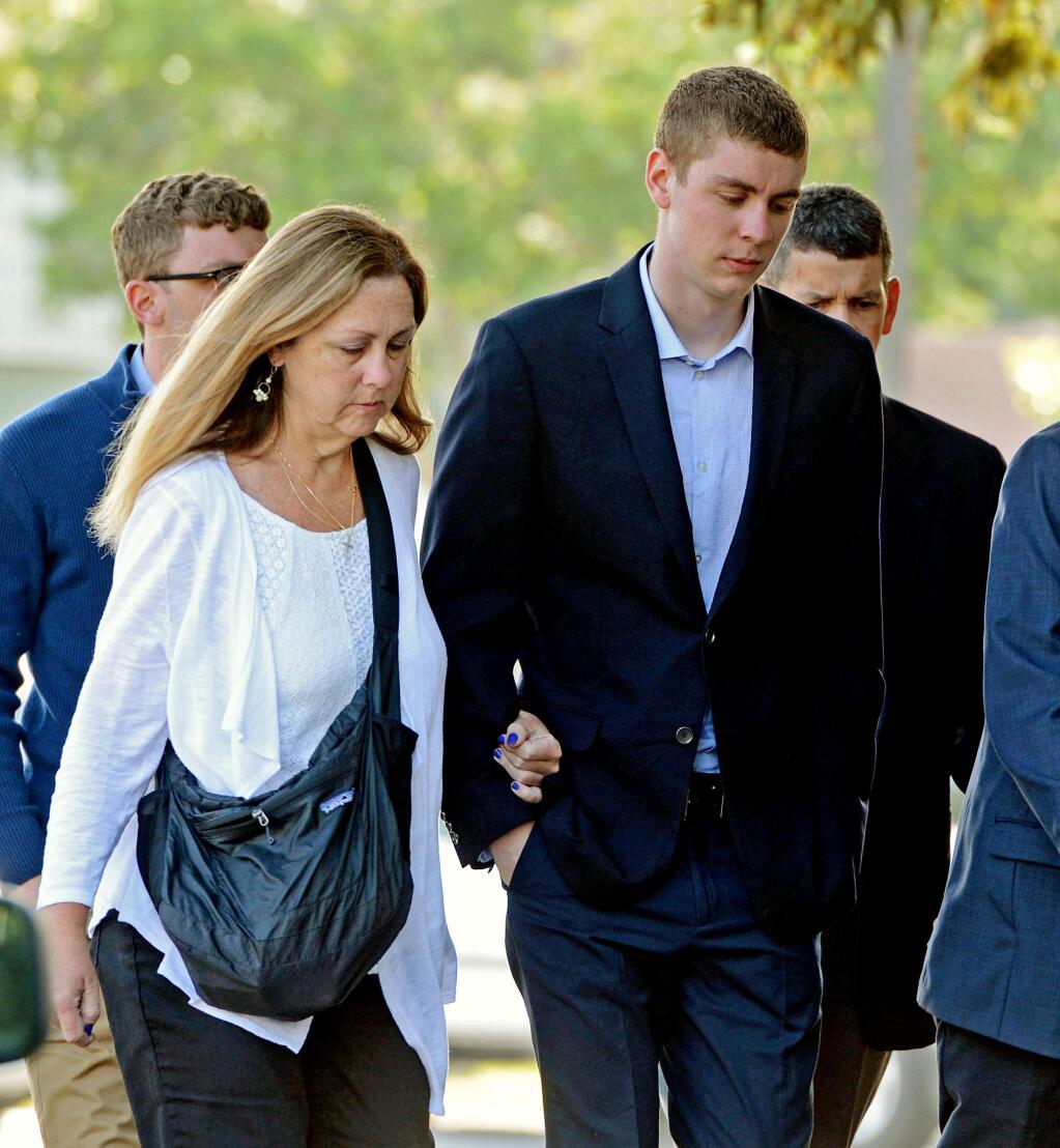 FILE - In this June 2, 2016 file photo, Brock Turner, right, makes his way into the Santa Clara Superior Courthouse in Palo Alto, Calif. A letter written by Turner's father was made public over the weekend by a Stanford law professor who wants the judge in the case removed from office because Brock Turner's sentencing. (Dan Honda/Bay Area News Group via AP, File)