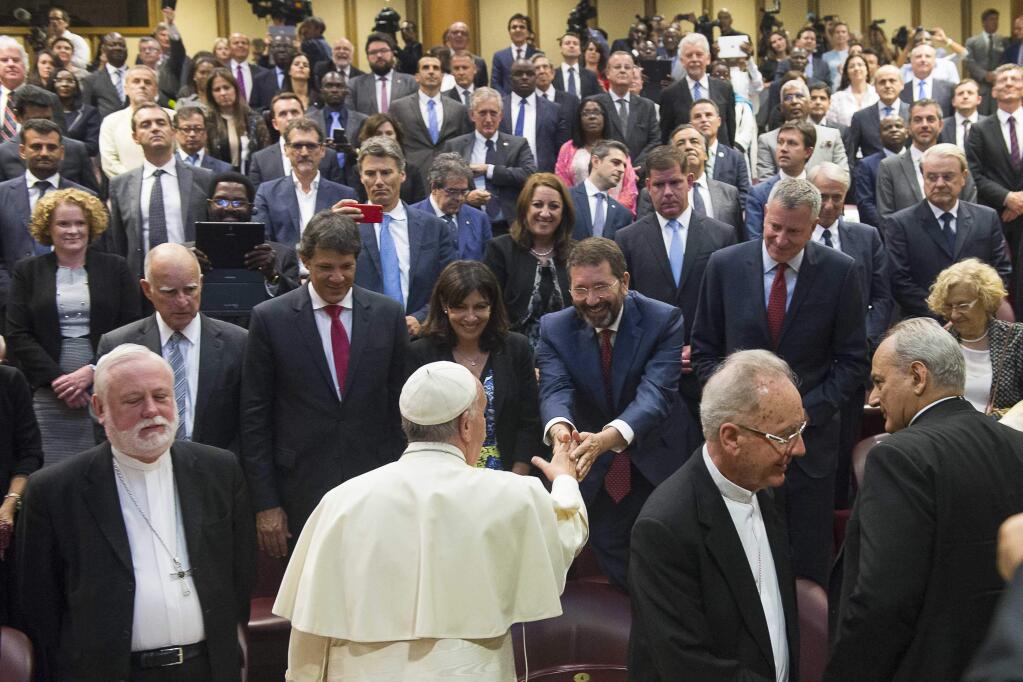Pope Francis greets Rome Mayor Ignazio Marino as he meets mayors and other officials at the climate change conference this week at the Vactican. (L'Ossservatore Romano via Associated Press)