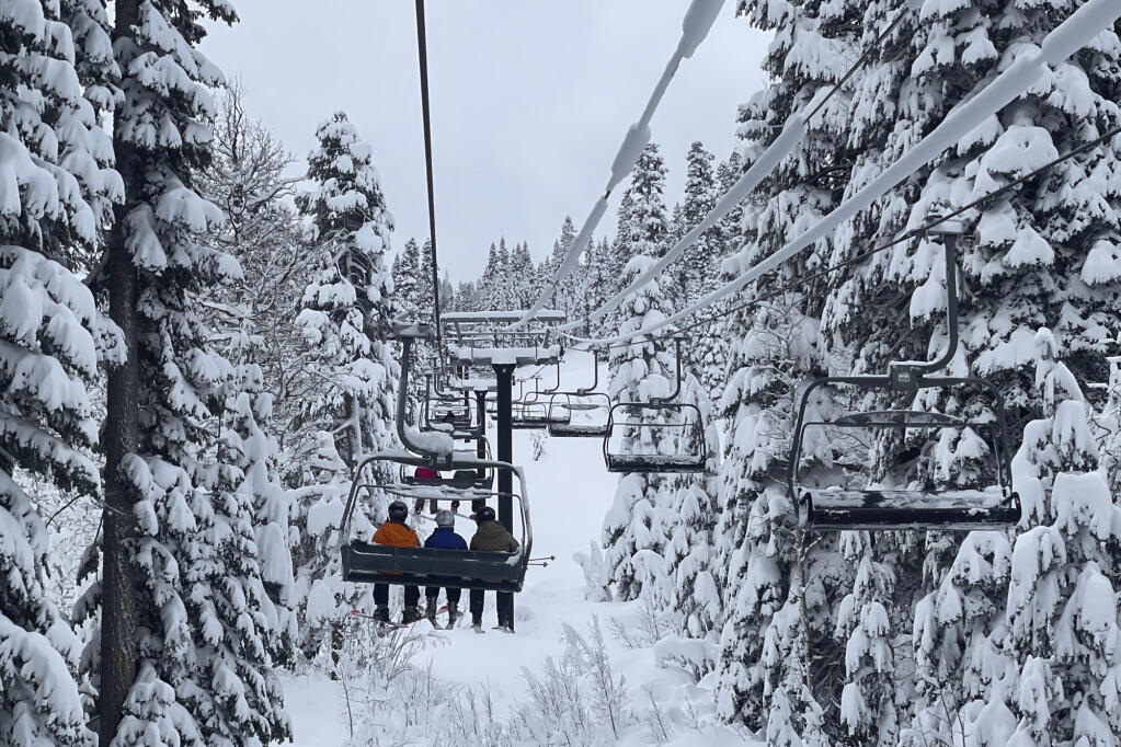 In this photo provided by the Northstar California, fresh snow from a storm surrounds a ski lift at the resort in Truckee, Calif., on Tuesday, Dec. 14, 2021. (Shannon Buhler/Northstar California via AP)
