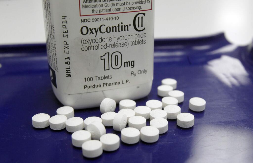 A bill pending in the state Senate would require physicians, dentists and other health professionals to check a state database before prescribing addictive medications such as OxyContin. (TOBY TALBOT / Associated Press)