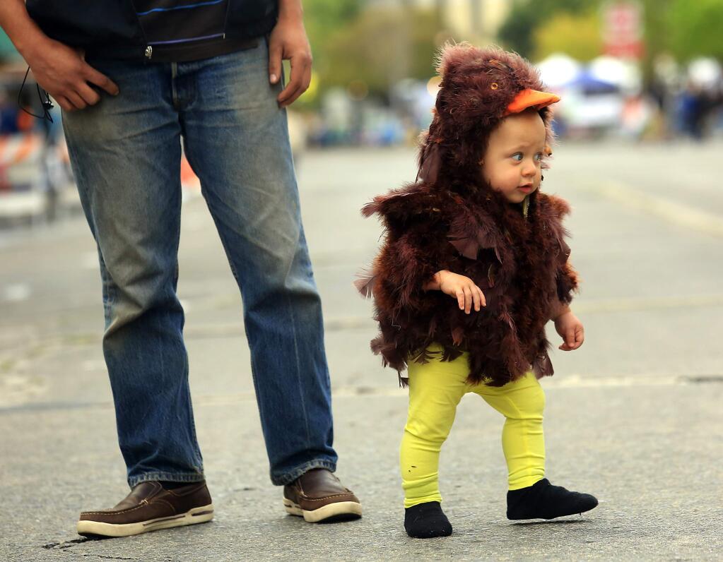 Israel Edwards, 1, tries to make a break for it before the Cutest Little Chick contest at Petaluma's Butter and Eggs Days on Saturday. (JOHN BURGESS / The Press Democrat)