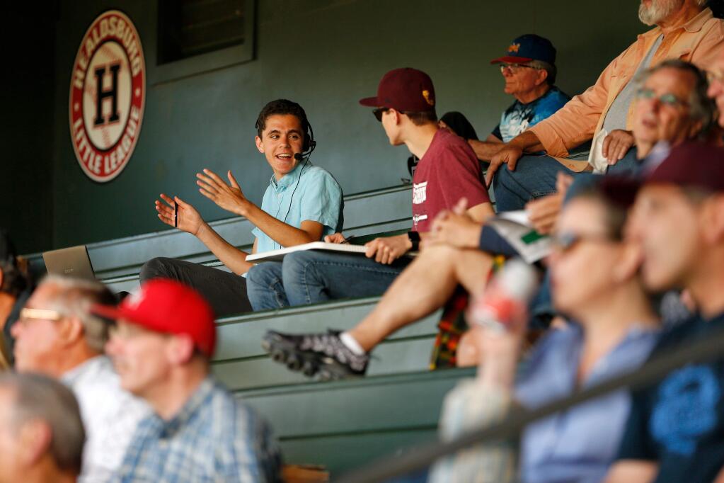 Griffin Epstein, upper left, banters with his friend and stats keeper Lucas Rumpler while calling the play-by-play action for streaming audio over the internet for a Healdsburg Prune Packers baseball game against the Humboldt Crabs, in Healdsburg, California, on Thursday, June 20, 2019. (Alvin Jornada / The Press Democrat)