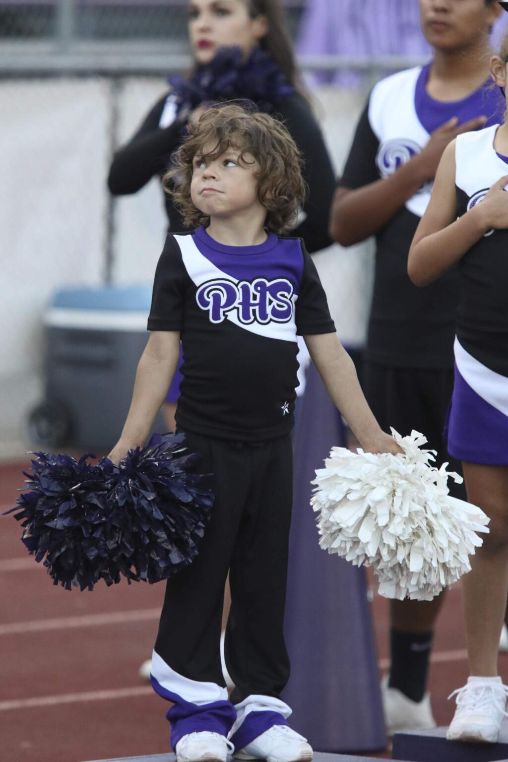 A small cheer leader cheers for the home team during the football game at Petaluma High School in Petaluma on Friday, August 28, 2015. Windsor went on to win the game 21-9. (SCOTT MANCHESTER/ARGUS-COURIER STAFF)