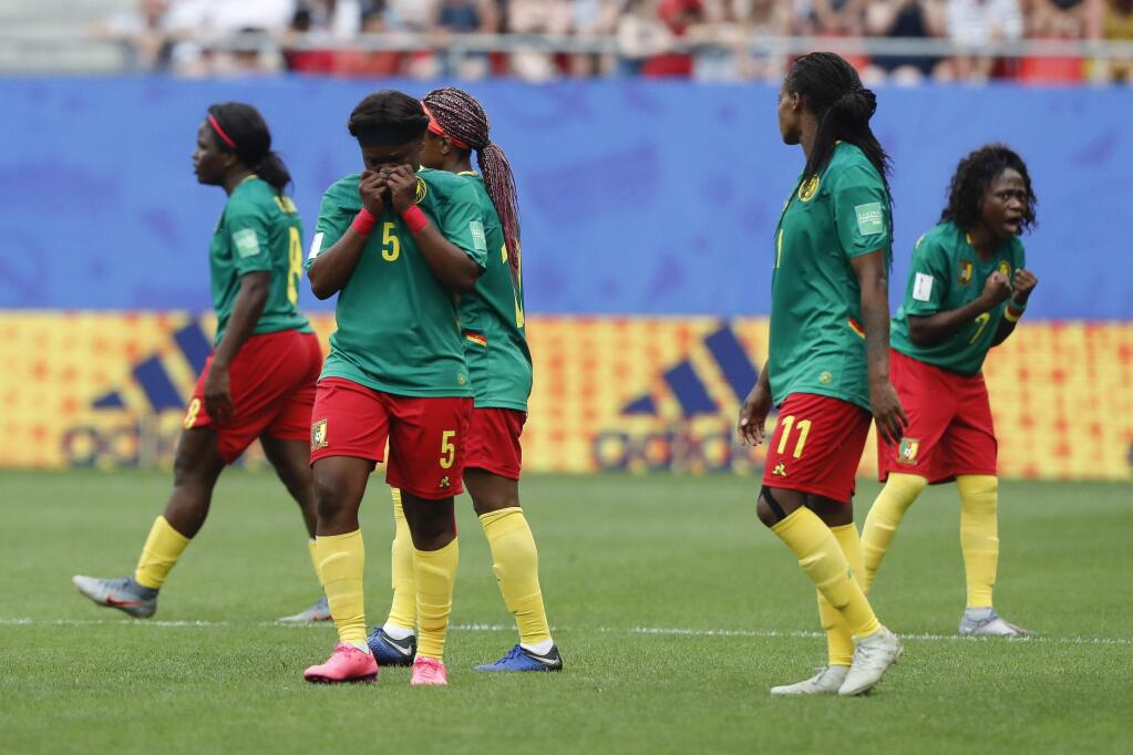 Cameron players react after a VAR decision that ruled out Ajara Nchout's goal for offside during the Women's World Cup game between England and Cameroon at the Stade du Hainaut stadium in Valenciennes, France, Sunday, June 23, 2019. (AP Photo/Michel Spingler)