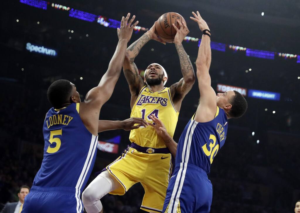 Los Angeles Lakers' Brandon Ingram (14) shoots between Golden State Warriors' Stephen Curry, right ,and Kevon Looney (5) during the first half of an NBA basketball game Monday, Jan. 21, 2019, in Los Angeles. (AP Photo/Marcio Jose Sanchez)