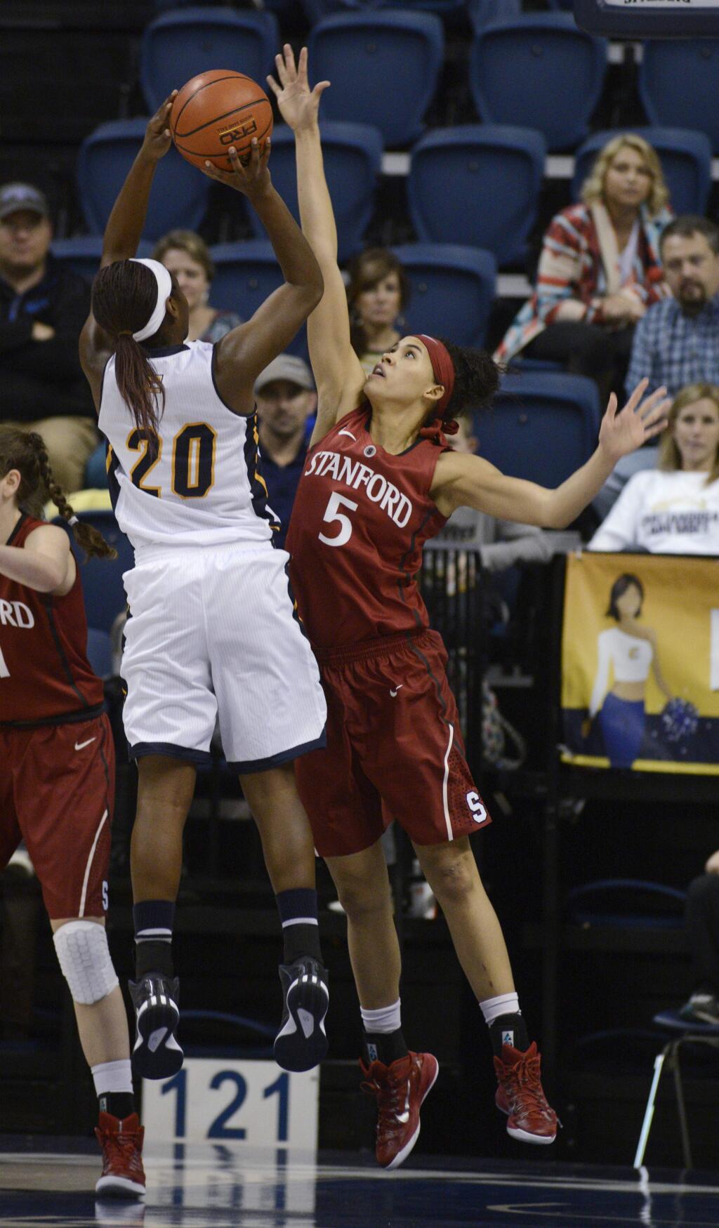 Stanford's Kaylee Johnson (5) blocks a shot by Chattanooga's Keiana Gilbert (20) during the first half of an NCAA college basketball game Wednesday, Dec. 17, 2014, in Chattanooga, Tenn. (AP Photo/Billy Weeks)