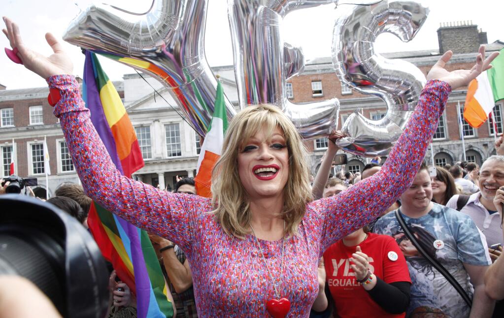 Rory O'Neill, known by the Drag persona Panti, celebrates with yes supporters at Dublin Castle, Ireland, Saturday, May 23, 2015. Ireland has voted resoundingly to legalize gay marriage in the world's first national vote on the issue, leaders on both sides of the Irish referendum declared Saturday even as official ballot counting continued. Senior figures from the 'no' campaign, who sought to prevent Ireland's constitution from being amended to permit same-sex marriages, say the only question is how large the 'yes' side's margin of victory will be from Friday's vote. (AP Photo/Peter Morrison)