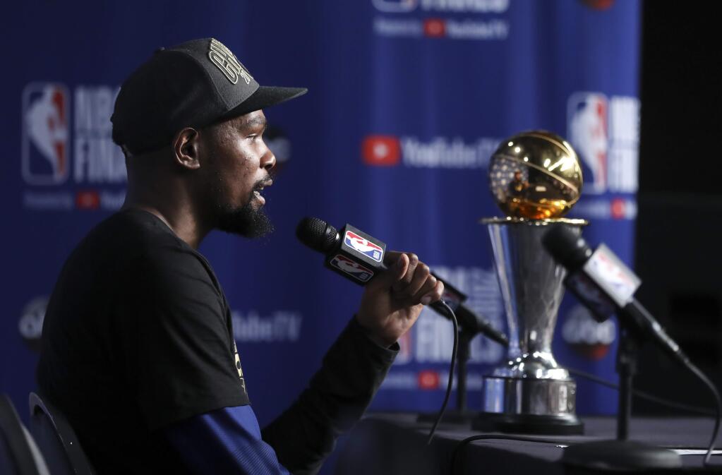 Golden State Warriors forward Kevin Durant speaks during a news conference following Game 4 of basketball's NBA Finals early Saturday, June 9, 2018, in Cleveland. The Warriors defeated the Cleveland Cavaliers 108-85 to take the title. Durant was named MVP of the finals. (AP Photo/Carlos Osorio)