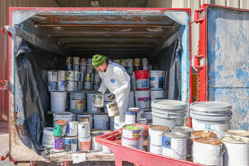 Imanol Fernandez loads paint into the paint care roll off area at the county’s Central Disposal Site near Petaluma, Friday, Oct. 20, 2023. (Christopher Chung / The Press Democrat)