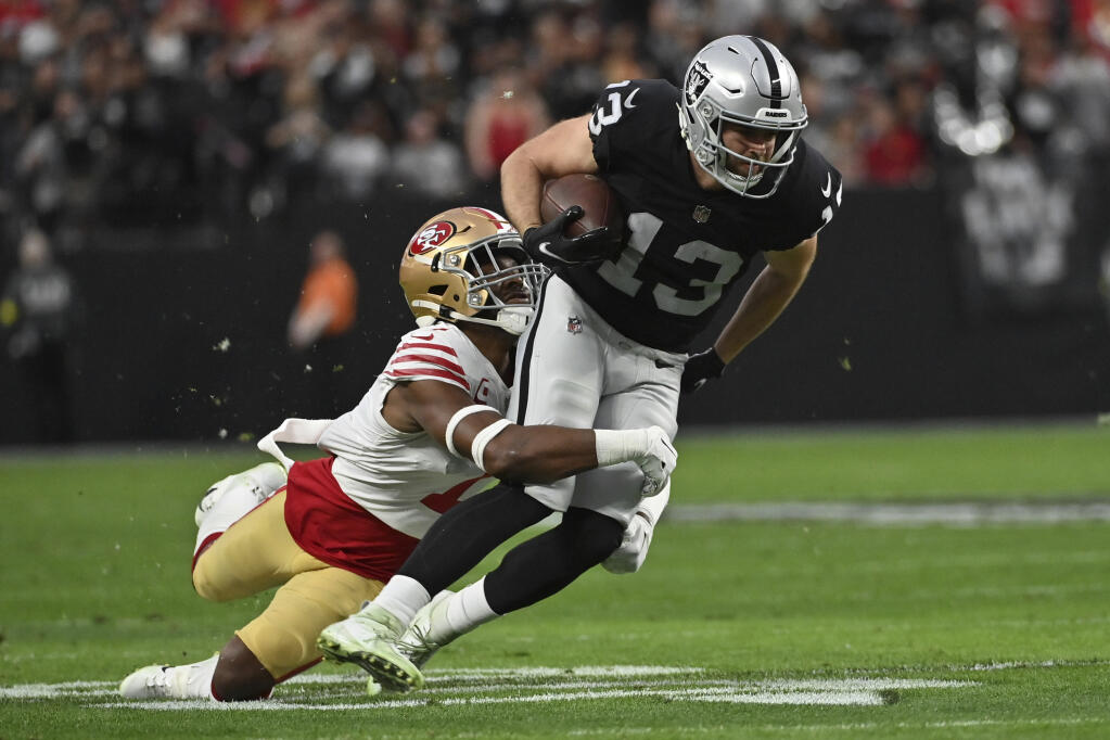 Las Vegas Raiders wide receiver Hunter Renfrow (13) is tackled by San Francisco 49ers cornerback Jimmie Ward (1) during the first half of an NFL football game between the San Francisco 49ers and Las Vegas Raiders, Sunday, Jan. 1, 2023, in Las Vegas. (AP Photo/David Becker)