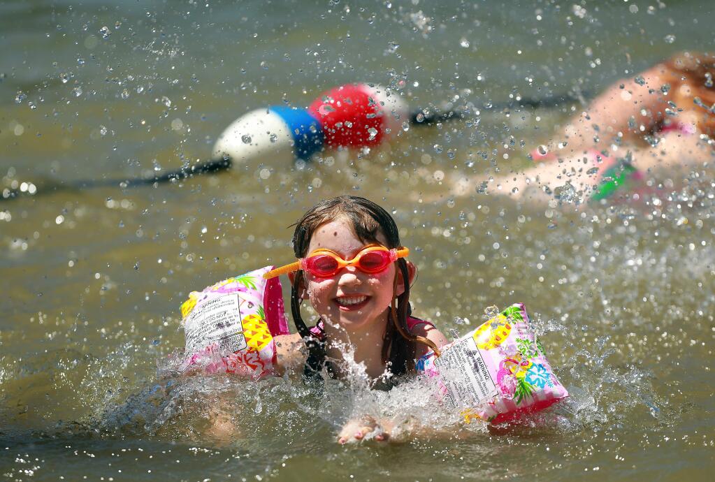 Santa Rosa set a record high for July 16 reaching 108 degrees Sunday. Claira Bush, 5, of Windsor, is shown swimming Saturday at the Healdsburg Water Carnival on the Russian River when it was a bit cooler: 100 degrees. (John Burgess/The Press Democrat)