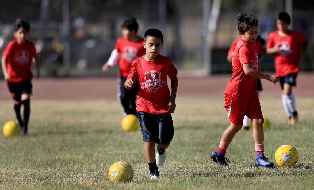 The Tahuichi Soccer Club's U8 boys participate in dribble drills during the team's practice on the athletic fields of Elsie Allen High School, Thursday June 14, 2018 in Santa Rosa. (Kent Porter / The Press Democrat) 2018