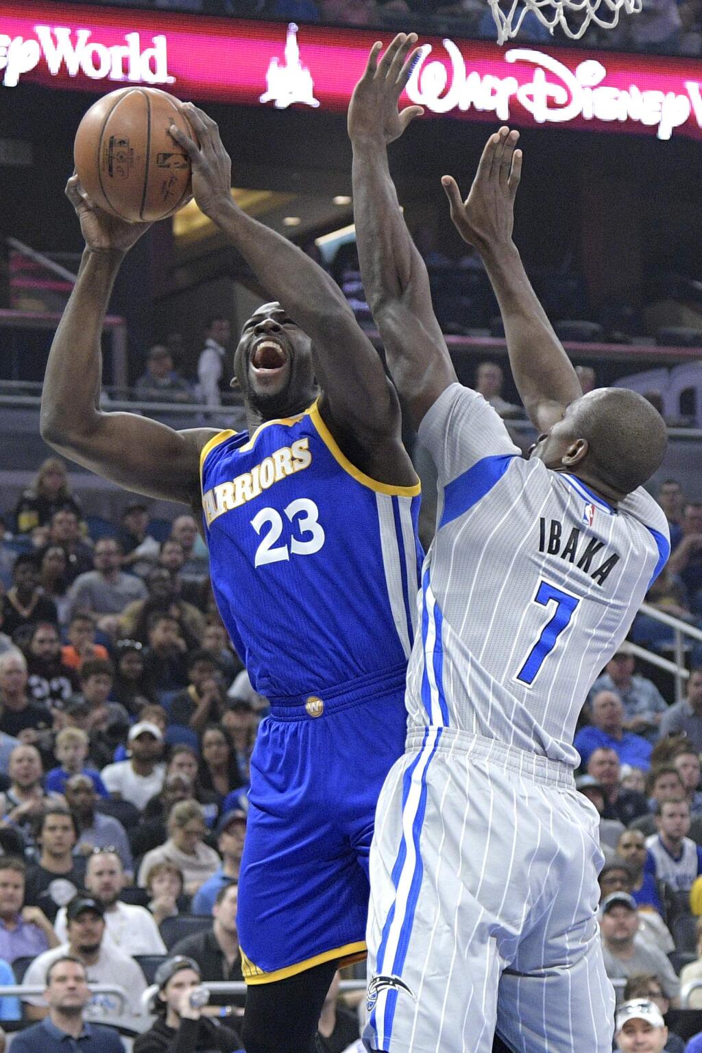 Golden State Warriors forward Draymond Green (23) is fouled by Orlando Magic forward Serge Ibaka (7) while going up for a shot during the first half of an NBA basketball game in Orlando, Fla., Sunday, Jan. 22, 2017. (AP Photo/Phelan M. Ebenhack)