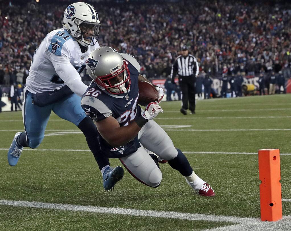 New England Patriots running back James White, right, runs past Tennessee Titans safety Kevin Byard (31) for a touchdown during the first half of an NFL divisional playoff football game, Saturday, Jan. 13, 2018, in Foxborough, Mass. (AP Photo/Charles Krupa)