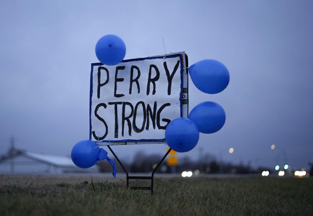 A sign along Highway 141 in Granger, Iowa, shows support for the neighboring community of Perry on Friday, Jan. 5, 2024, following a shooting at the Perry Middle School and High School building the previous day. (AP Photo/Bryon Houlgrave)