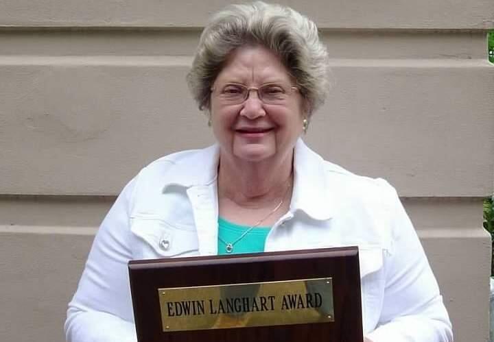Outside the Healdsburg Museum in 2011, Darla Budworth displays the Edwin Langhart Award that acknowledged her years of service as a museum volunteer. (Budworth family)