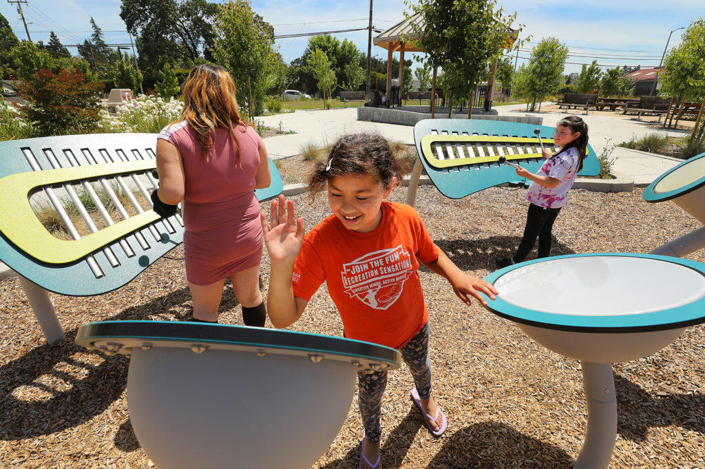 From left, Juanita Tlahuitzo plays instruments with her daughters Illyanna, 9, and Mercedes, 7, at Andy’s Unity Park in southwest Santa Rosa on Wednesday. The Board of Supervisors banned the use of insecticides in county playgrounds plazas and parks. (photo by John Burgess/The Press Democrat)