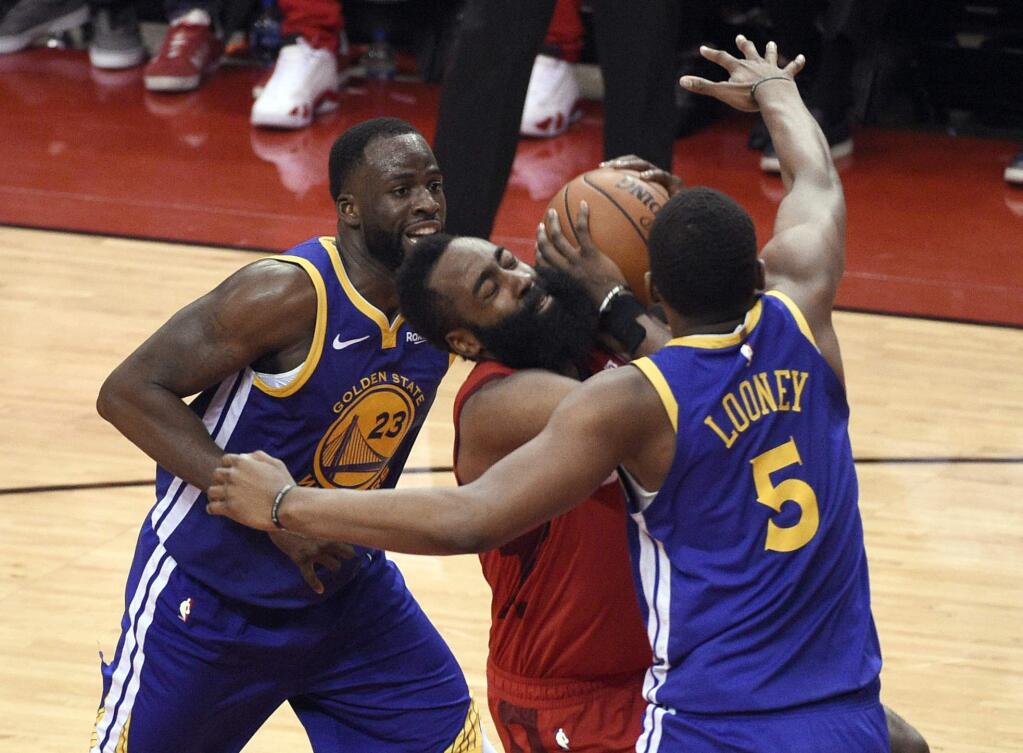 The Golden State Warriors' Draymond Green (23) and Kevon Looney (5) defend against the Houston Rockets' James Harden (13) during the second half of Game 6 of a second-round NBA playoff series Friday, May 10, 2019, in Houston. (AP Photo/Eric Christian Smith)