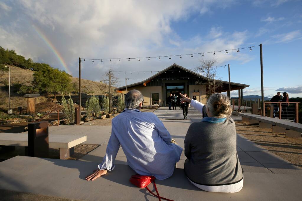 Former property manager Fernando Marquez and friend Marleen Mulder, who both lost their residences during the Tubbs Fire, sit outside and enjoy a rainbow during the grand reopening party of Paradise Ridge Winery in Santa Rosa on Sunday, December 8, 2019. (BETH SCHLANKER/ The Press Democrat)