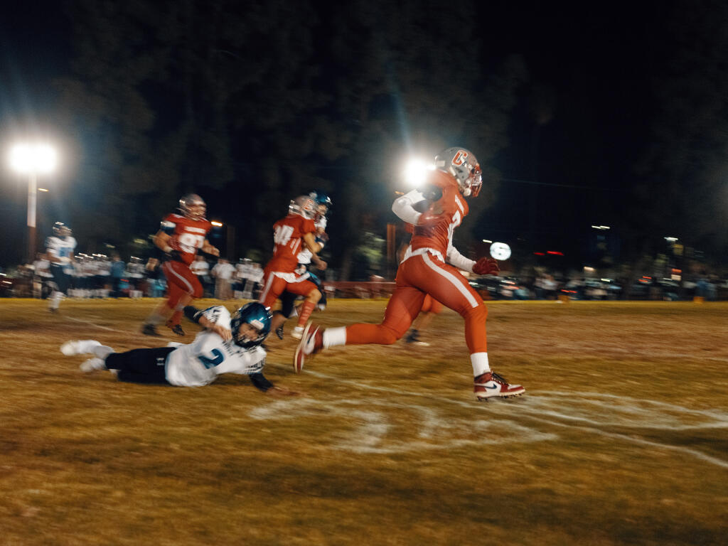 Running back Enos Zornoza of the California School for the Deaf, Riverside, sprints past a Desert Christian Knights defender in Riverside, Calif., on Friday night, Nov. 12, 2021. The football teamÕs success has given the school and the surrounding community a lift. (Adam Perez/The New York Times)