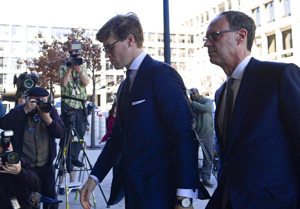 Alex van der Zwaan, left, arrives at Federal District Court in Washington, Tuesday, Feb. 20, 2018. Van der Zwaan has been accused of lying to investigators about his interactions with Rick Gates, who was indicted last year along with Paul Manafort, President Donald Trump's campaign chairman, on charges of conspiracy to launder money and acting as an unregistered foreign agent. (AP Photo/Susan Walsh)