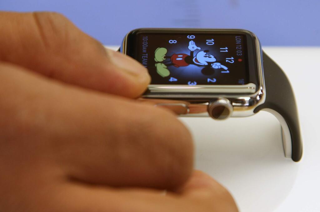 FILE - In this April 10, 2015 file photo, a customer handles an Apple Watch at an Apple store in Sydney. U.S. retailer Best Buy Co. says it will sell the Apple Watch at 100 of its stores and on its website beginning Aug. 7, 2015. (AP Photo/Rick Rycroft)