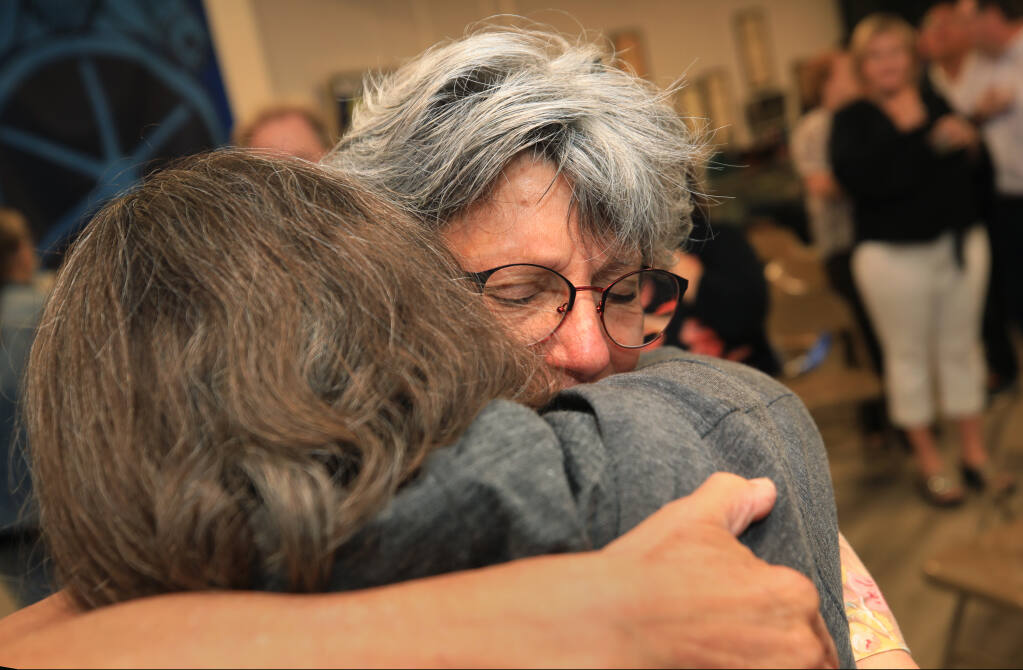 Sonoma County District Attorney Jill Ravitch, right, embraces her sister Amy Friedricks as she reacts after garnering 80% of the early returns in her recall election, Tuesday, Sept. 14, 2021 in Santa Rosa. (Kent Porter / The Press Democrat) 2021