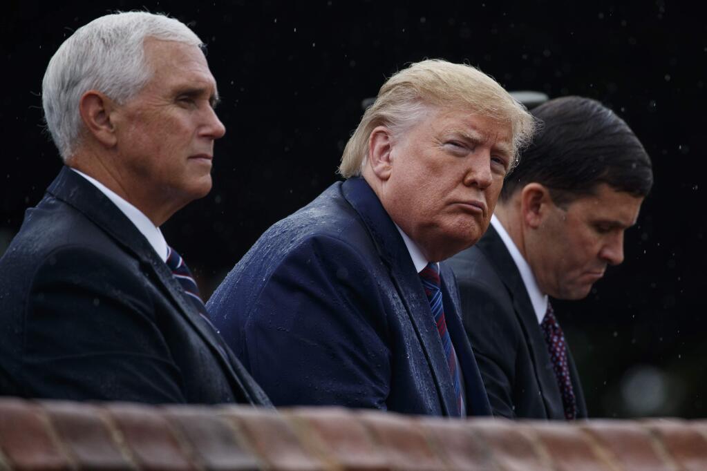 From left, Vice President Mike Pence, President Donald Trump, and Defense Secretary Mark Esper, participate in an Armed Forces welcome ceremony for the new chairman of the Joint Chiefs of Staff, Gen. Mark Milley, Monday, Sept. 30, 2019, at Joint Base Myer-Henderson Hall, Va. (AP Photo/Evan Vucci)