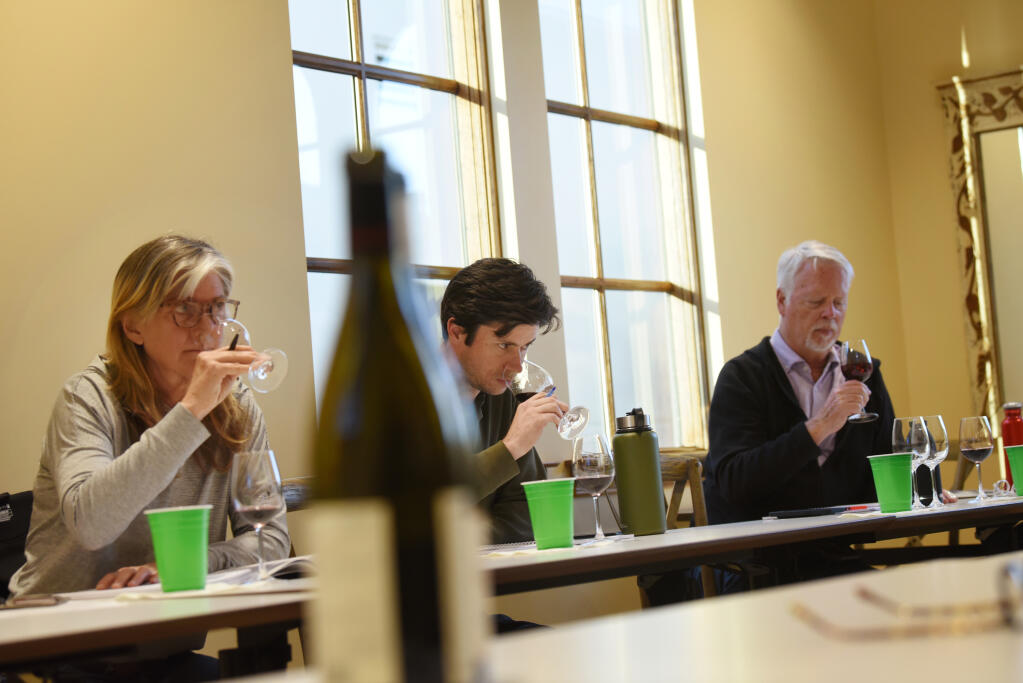 From left, Shirley Lenehan, Taylor Shoptaw,  both who work in the wine industry and Doug Garrett, a local retiree, during a wine education class focusing on a few varietals from France and Spain at the Odyssey Wine Academy held at Bacchus Landing in Healdsburg, Calif., Tuesday, March 15, 2022. (Photo: Erik Castro/for The Press  Democrat)