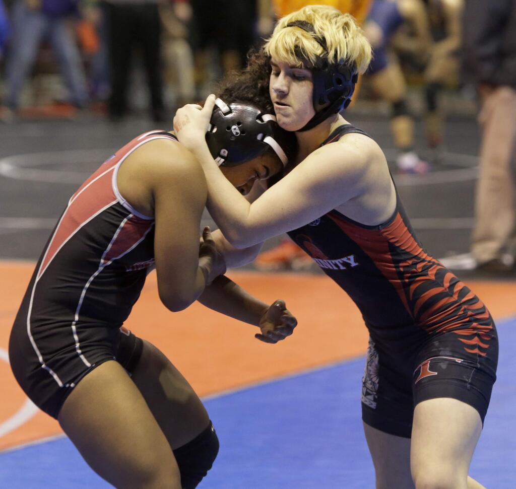 Mack Beggs, right, a wrestler from Trinity High in Euless, competes in a quarterfinal match against Mya Engert of Tascosa High in Amarillo during the Texas state wrestling tournament on Friday in Cypress, Texas. Beggs was born a female and is transitioning to male but has beenis required to wrestle in the girls division. (Melissa Phillip/Houston Chronicle via AP)