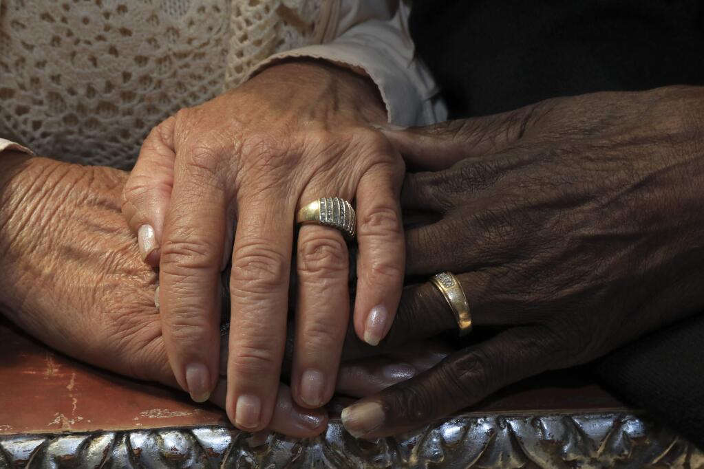 Rosina and Leon Watson with their wedding bands in Oakland, Calif., June 9, 2017. They were among the first interracial couples to marry in California, 17 years before it was allowed nationwide in a landmark Supreme Court case. (Jim Wilson / New York Times)