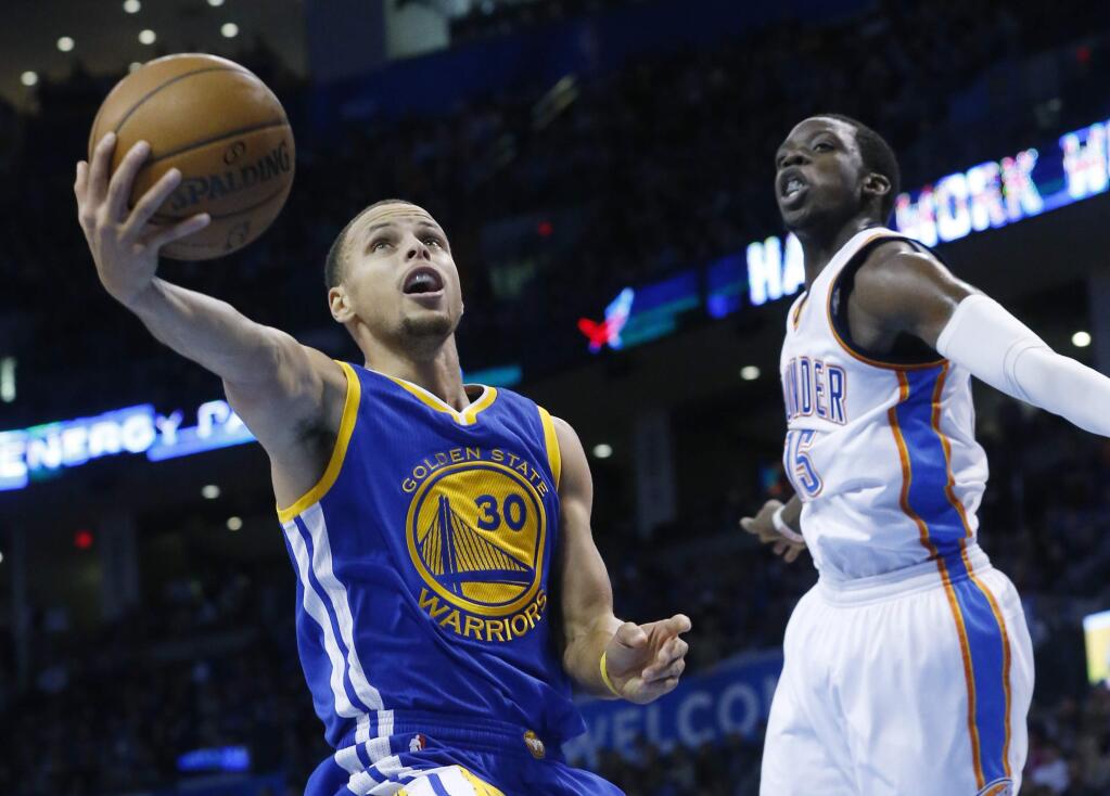 Golden State Warriors guard Stephen Curry (30) shoots in front of Oklahoma City Thunder guard Reggie Jackson (15) in the first quarter of an NBA basketball game in Oklahoma City, Sunday, Nov. 23, 2014. (AP Photo/Sue Ogrocki)
