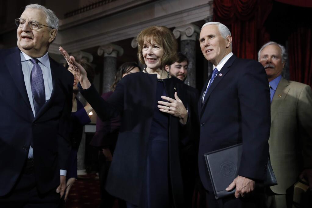 Vice President Mike Pence, right, stands with Sen. Tina Smith, D-Minn., center, and former Vice President Walter Mondale, left, before administering the Senate oath of office during a mock swearing in ceremony in the Old Senate Chamber Wednesday, Jan. 3, 2018 on Capitol Hill in Washington. (AP Photo/Jacquelyn Martin)