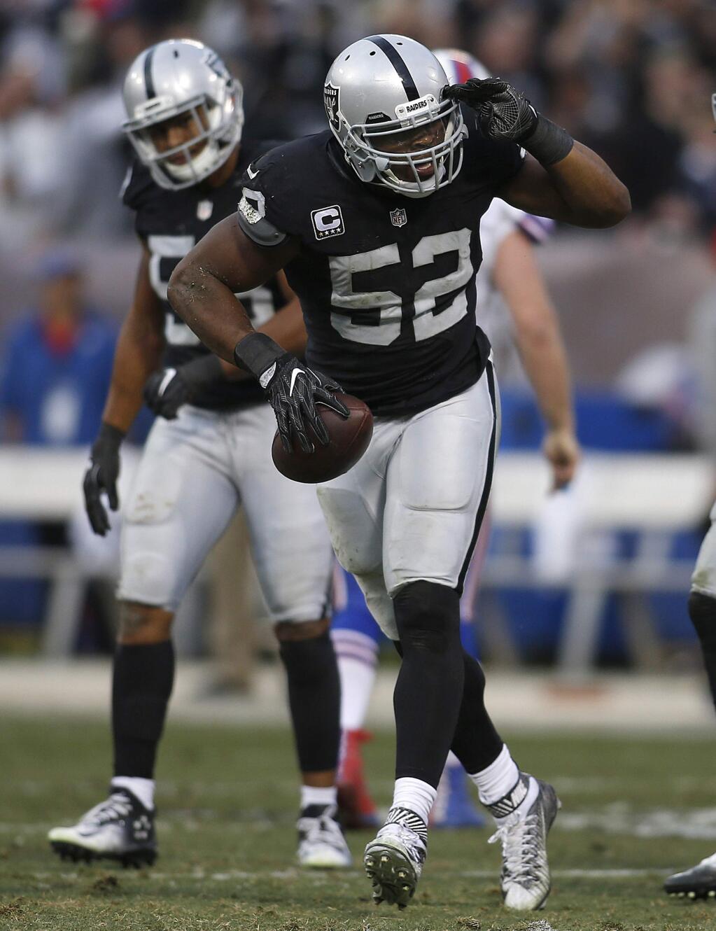 Oakland Raiders defensive end Khalil Mack (52) celebrates after recovering a fumble during the second half of an NFL football game against the Buffalo Bills in Oakland, Calif., Sunday, Dec. 4, 2016. The Raiders won 38-24. (AP Photo/D. Ross Cameron)
