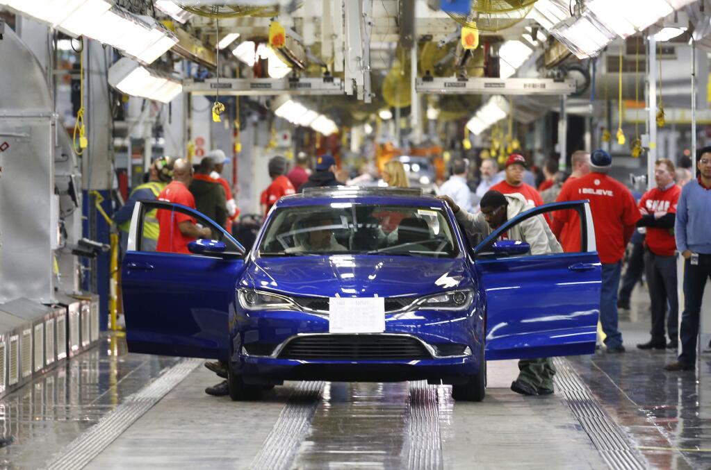 In this March 14, 2014 file photo, a 2015 Chrysler 200 automobile moves down the assembly line at the Sterling Heights Assembly Plant in Sterling Heights, Mich. Automakers report sales for May on Tuesday, June 3, 2014. All automakers report U.S. sales figures for August 2014 on Wednesday, Sept. 3, 2014. Chrysler and Nissan both posted double-digit U.S. sales gains last month, signs of strong August for the industry. (AP Photo/Paul Sancya, File)
