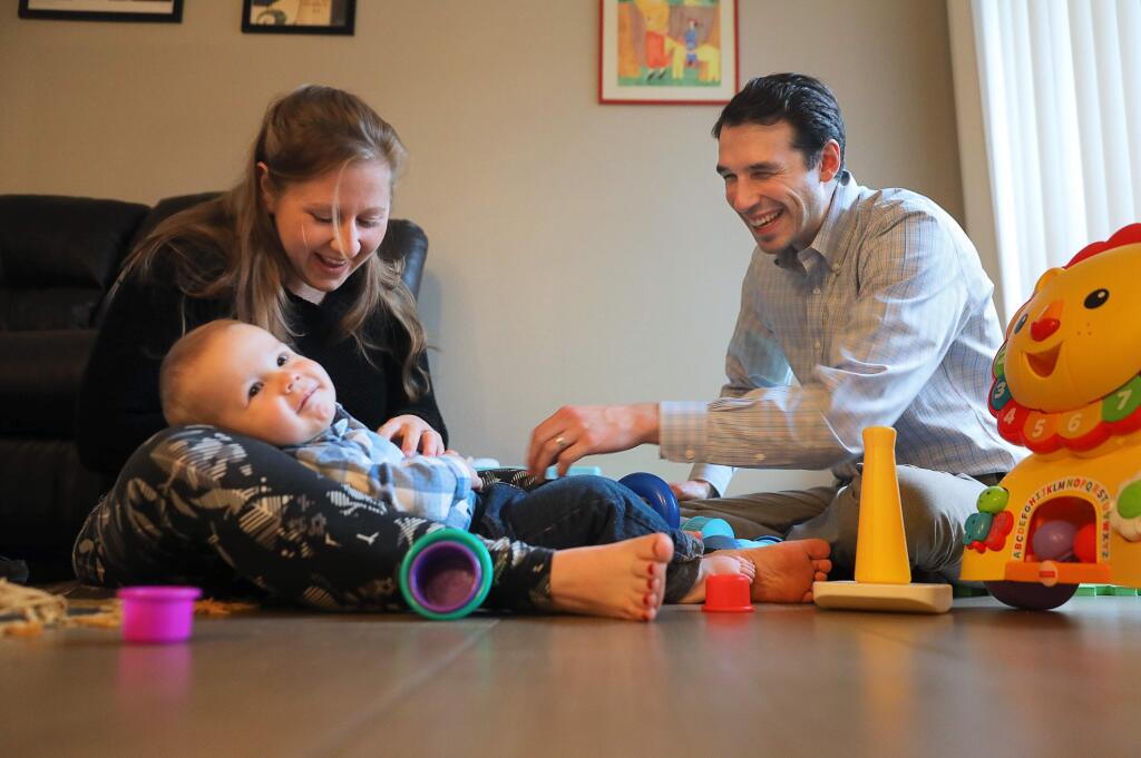 Santa Rosa High School teacher Nightsnow Vogt, right, and his wife, Melissa, play with their 13-month-old son, Camilo, in their Santa Rosa apartment on Tuesday, February 26, 2019. (Christopher Chung/ The Press Democrat)
