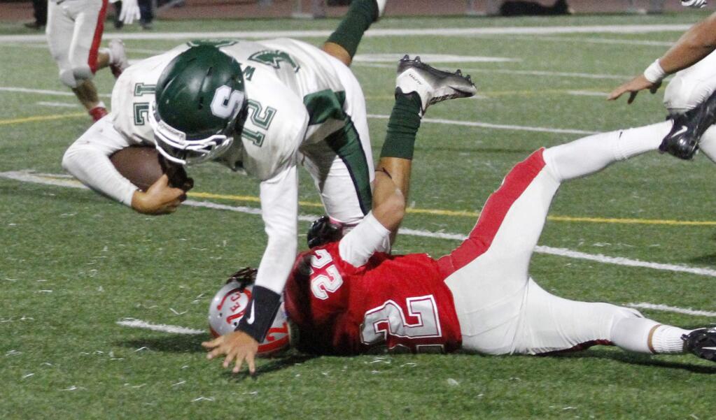 Bill Hoban/Index-TribuneSonoma quarterback Rocko Wetzel dives over an El Camino defender in Friday night's game in South San Francisco. Sonoma lost to El Camino 20-12 and face Montgomery on Friday.