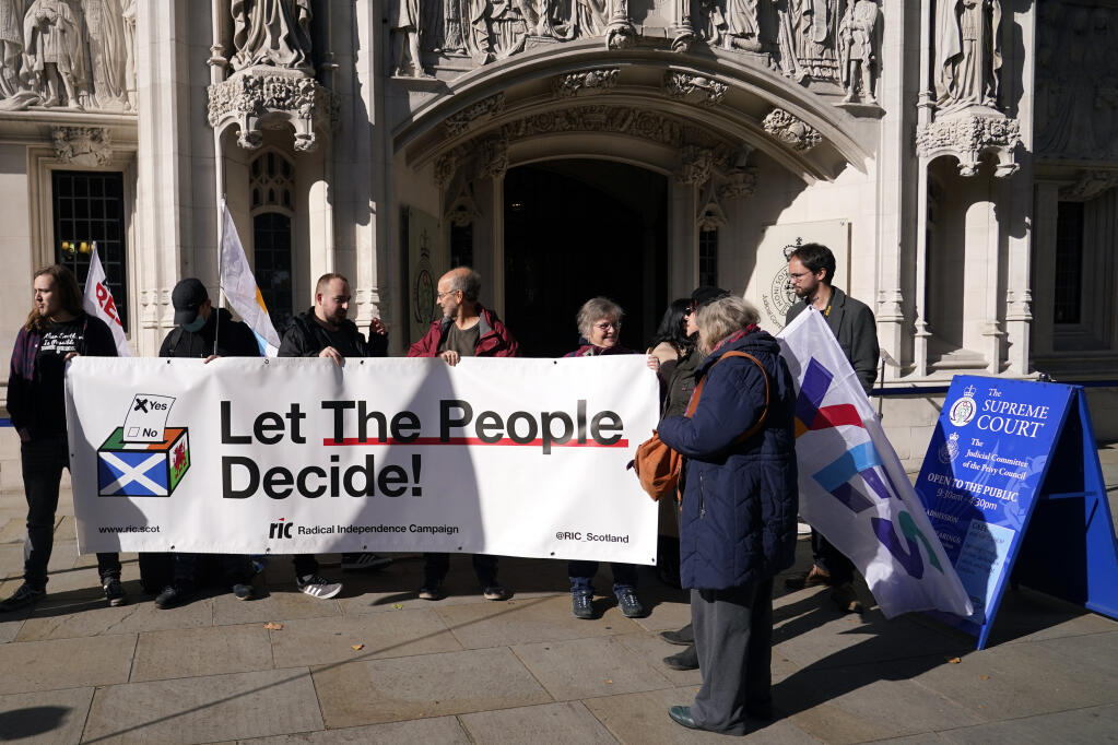FILE - Supporters of Scottish Independence hold a banner outside the Supreme Court in London, Tuesday, Oct. 11, 2022. Britain’s Supreme Court is due to rule Wednesday, Nov. 23, 2022, on whether Scotland can hold a vote on independence without the consent of the U.K. government, a case with huge implications for the future of the United Kingdom. (AP Photo/Alberto Pezzali, File)