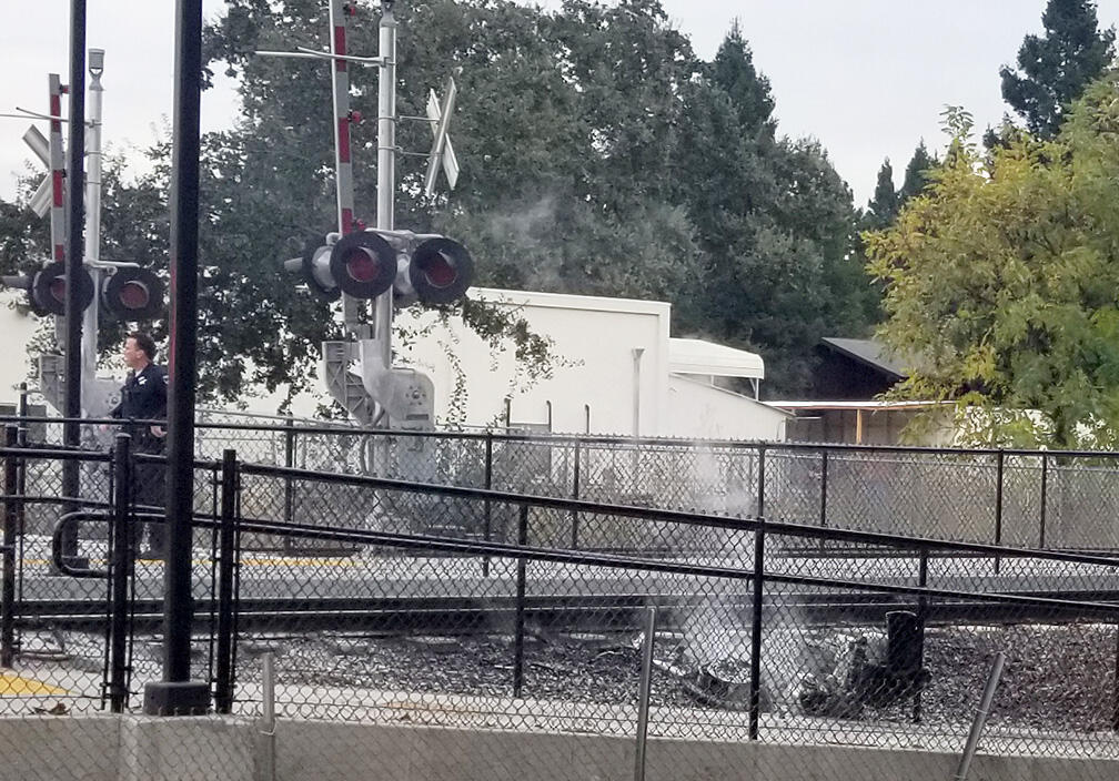 The wreckage of a motorcycle smolders after it collided with a SMART train, killing the motorcycle driver, at the intersection of Guerneville Road and the SMART train tracks in Santa Rosa, California, on Wednesday, November 13, 2019. (Photo courtesy of Dave Lind)