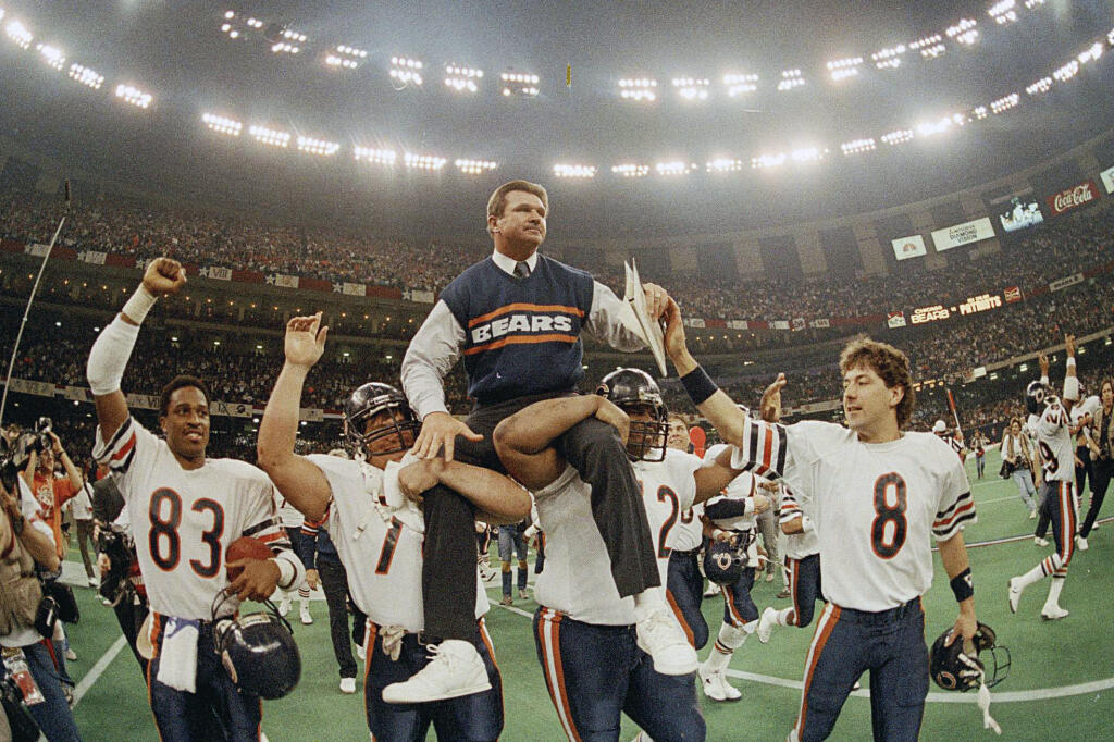 FILE- In this Jan. 26, 1986, file photo, Chicago Bears head coach Mike Ditka is carried off the field by Steve McMichael, left, and William Perry after the Bears defeated the New England Patriots 46-10 in  Super Bowl XX in New Orleans. Argue all you want about which is the best team in NFL annals. The Pro Football Hall of Fame has opted for the 1985 Chicago Bears. The Canton shrine will premiere "85: THE GREATEST TEAM IN FOOTBALL HISTORY" on Jan. 3. It will then hit theaters nationwide on Jan. 29.  (AP Photo/Phil Sandlin, File)