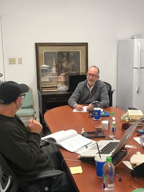 Joe Rodota Jr., seated at the head of the table, goes over a play script Wednesday, Jan. 29 in Santa Rosa with director Rob Olmsted. Austin Murphy/The Press Democrat