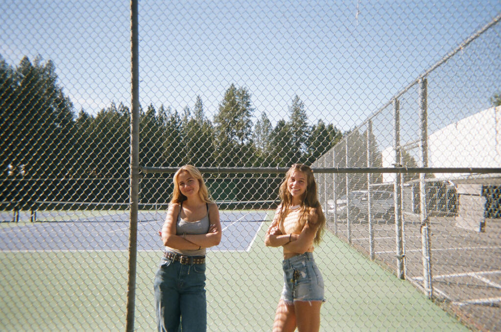 From left to right, tennis players Rowan Muir and Dakota Lunsford at the school’s tennis courts. "I was really disappointed that our Fresno tournament was canceled because of COVID. The tournament is my favorite event in the tennis season and I didn't get to go my senior year,” Dakota said.Photo by Madeline Hannebrink-Vance