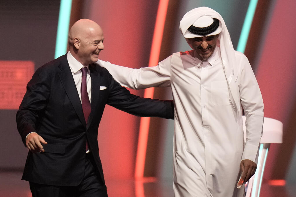 FIFA president Gianni Infantino, left, and Emir of Qatar Sheikh Tamim bin Hamad Al Thani leave the stage before April’s World Cup draw in Doha, Qatar. (Hassan Ammar / ASSOCIATED PRESS)