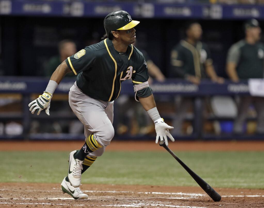 The Oakland Athletics' Khris Davis watches his home run off Tampa Bay Rays pitcher Jaime Schultz during the 10th inning Friday, Sept. 14, 2018, in St. Petersburg, Fla. Oakland defeated Tampa Bay 2-1. (AP Photo/Chris O'Meara)