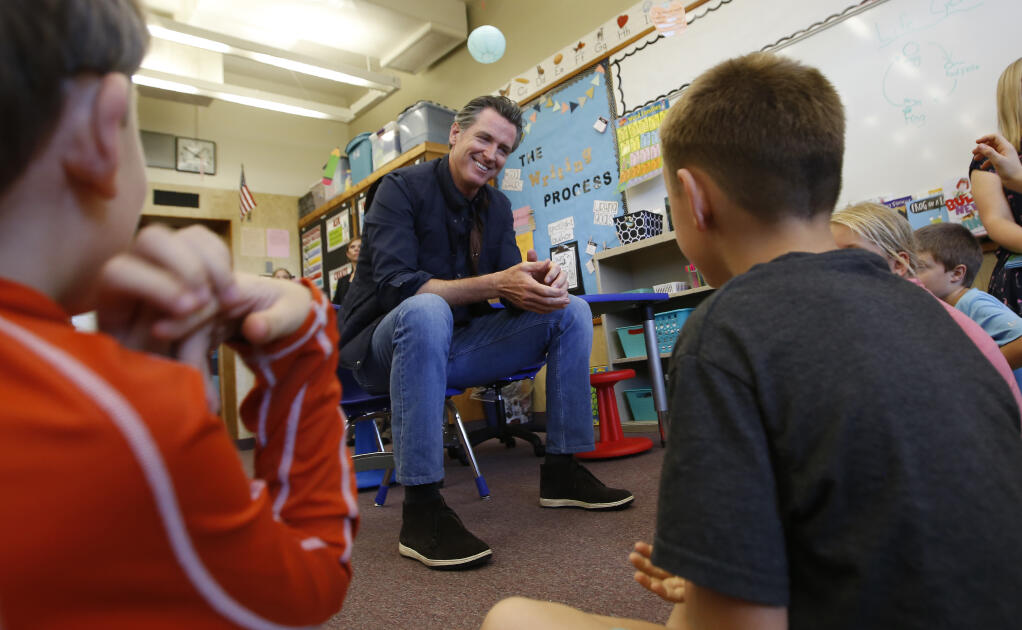 FILE - In this Aug. 21, 2019 file photo Gov. Gavin Newsom takes questions from second graders during his visit to the Paradise Ridge Elementary School in Paradise, Calif. Newsom is scheduled to unveil his 2021-22 proposed budget on Friday Jan. 8, 2021. Newsom's budget will include at least $2 billion to help schools with testing, increased ventilation and personal protective equipment. (AP Photo/Rich Pedroncelli, Pool, File)